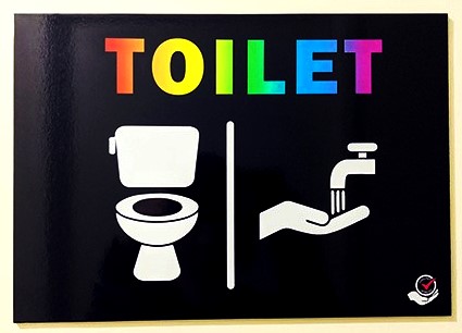 Sign for toilet in rainbow font with images of a toilet and hand washing